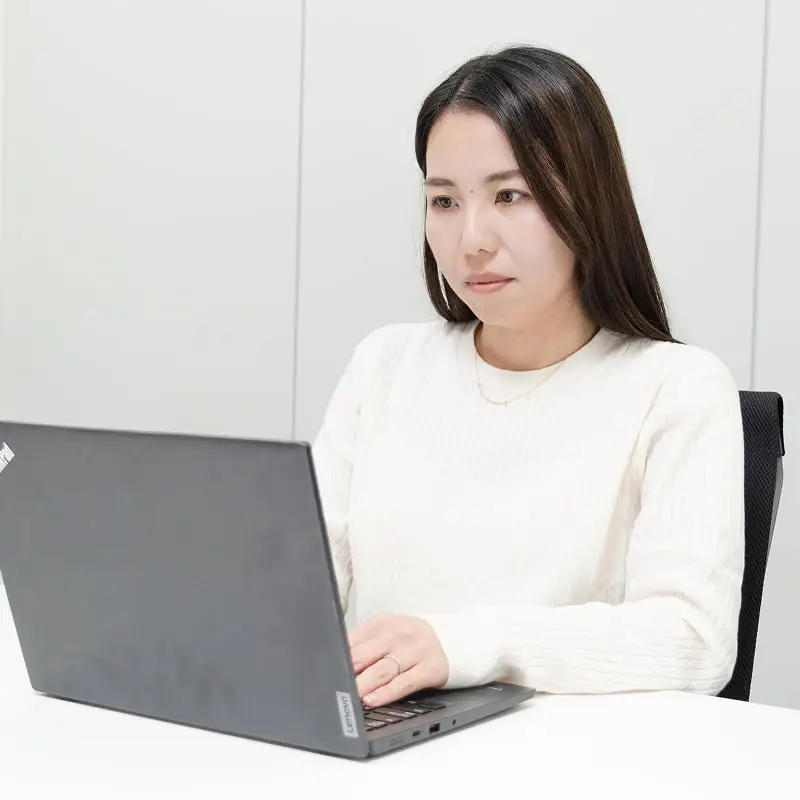 ノートパソコンを操作する女性社員